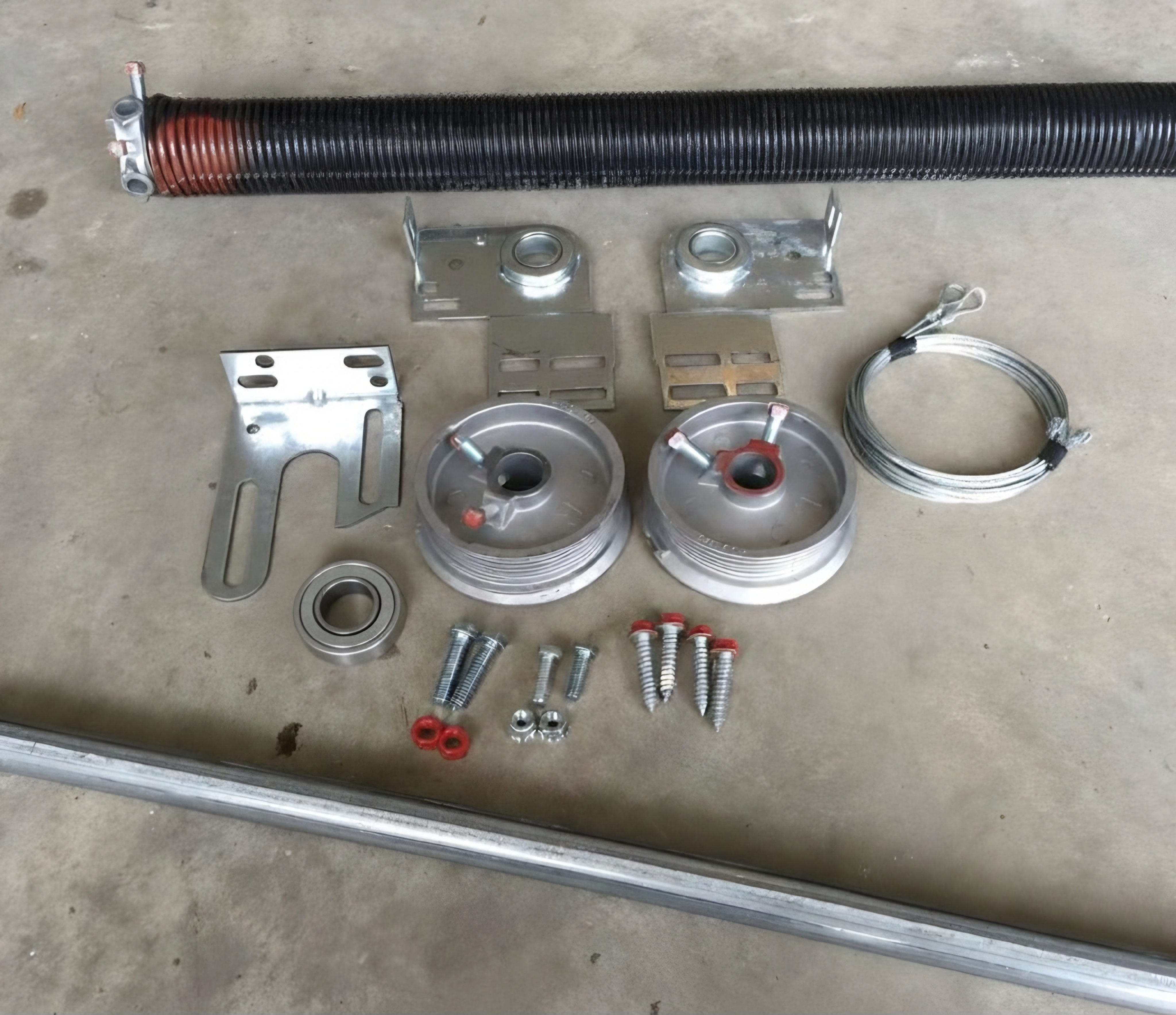 Torsion spring conversion components including springs, drums, bearings, cables, and mounting hardware